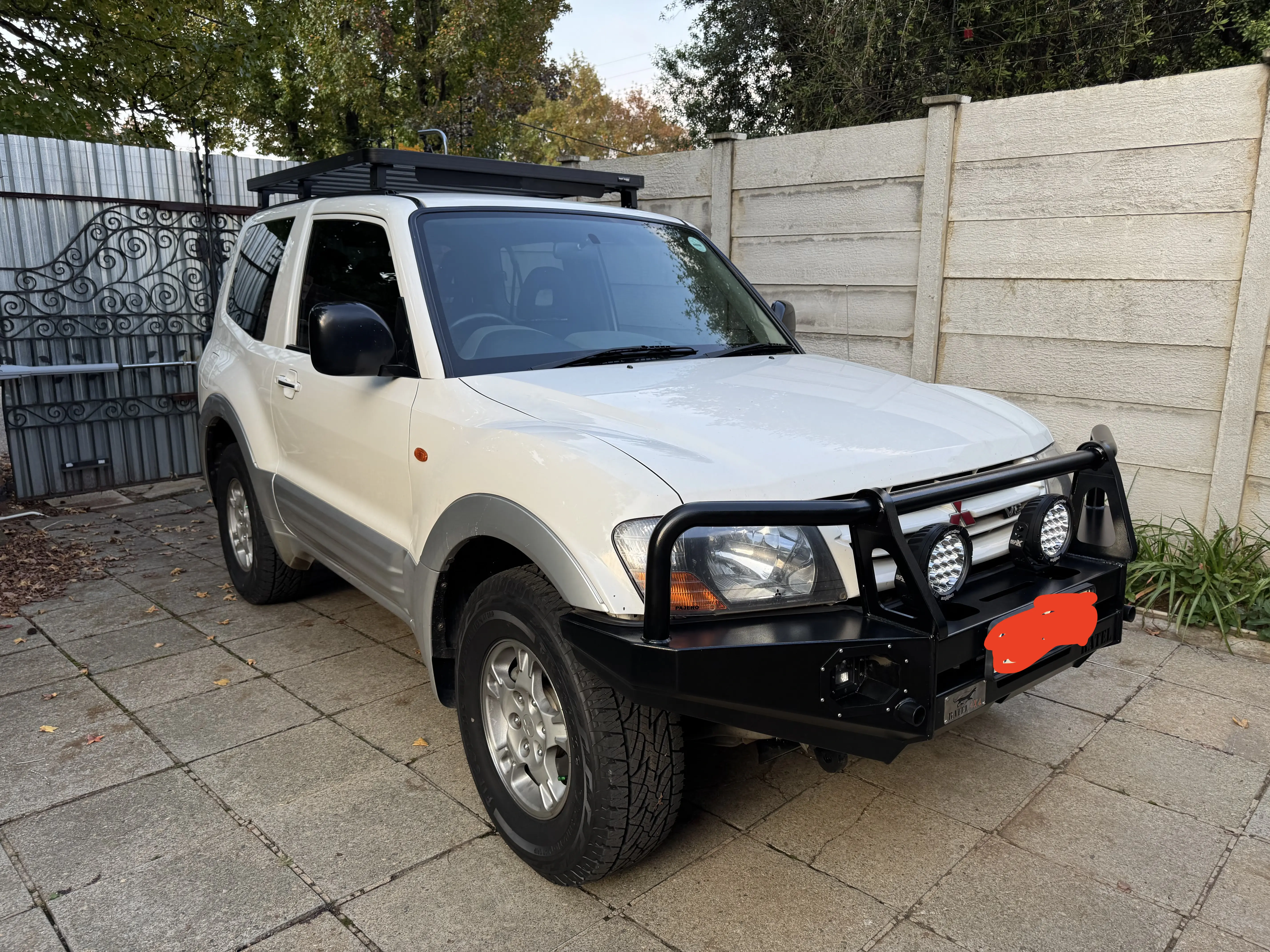 Jimmy's 2001 Mitsubishi Pajero Gen 2 SWB, 3.5 V6 petrol, white with bull bar and roof rack