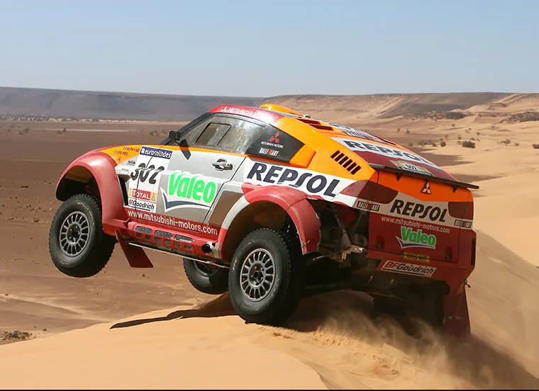 2006 Mitsubishi Pajero Evolution jumping through desert dunes on the Dakar Rally