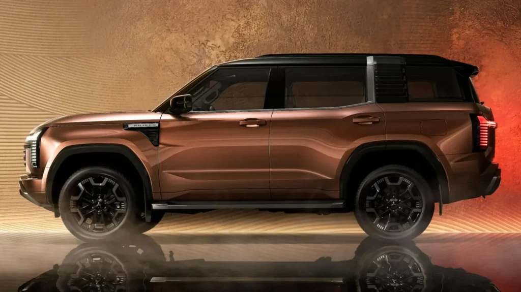 Side profile of the new Mitsubishi Pajero showing its boxy ladder-frame proportions, black contrast roof and 20-inch alloy wheels